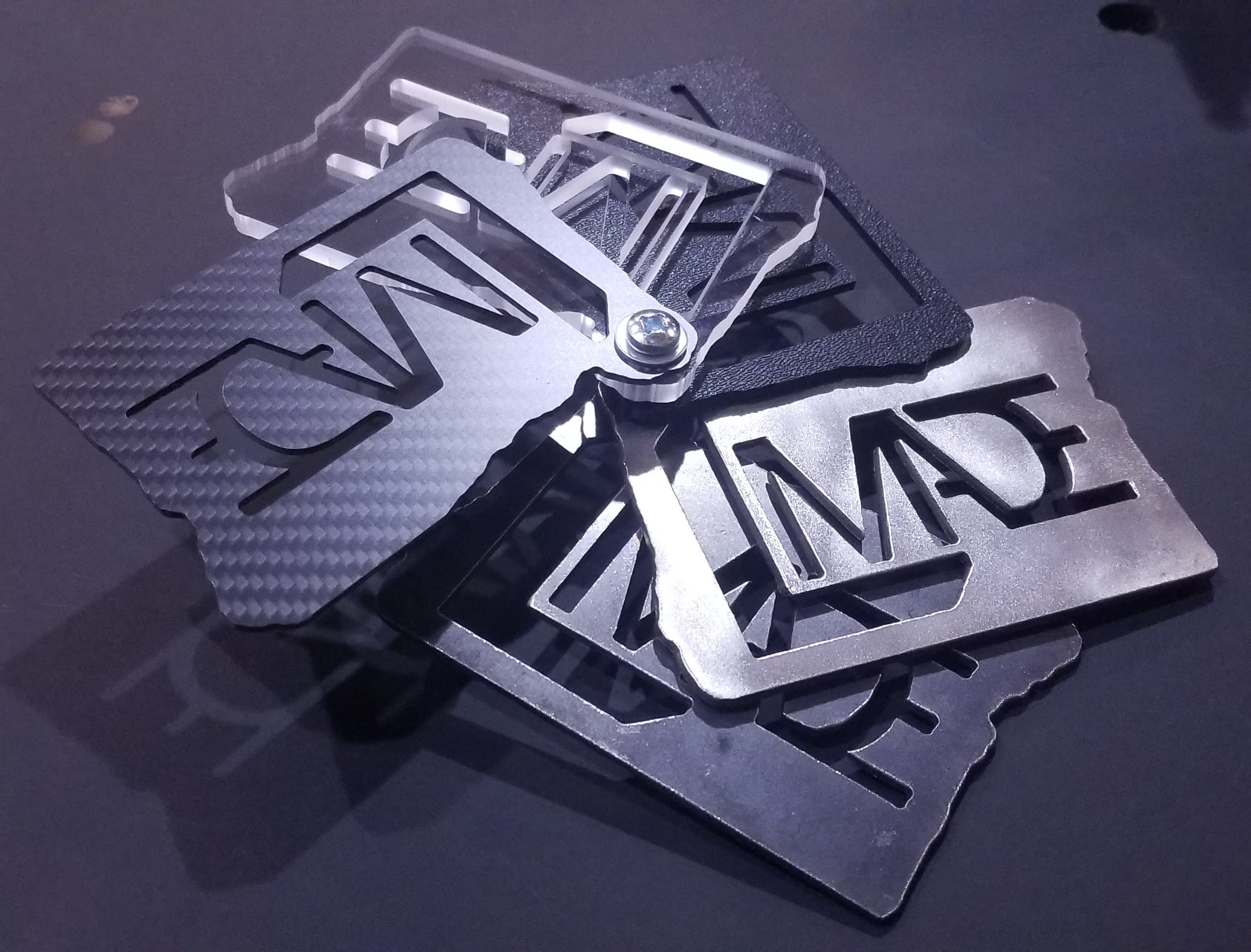 ledoux made material sample, ledoux made logo in steel, stainless steel, abs plastic, acrylic, and carbon fiber